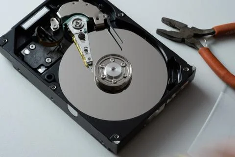 Hard drive from the computer hdd with mirror effect. And repair tools. Stock Photos