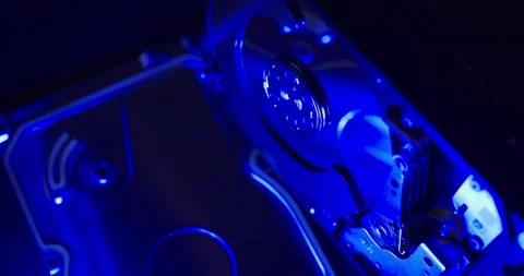 Hard Drive from side, spinning up Hard Disk. Blue light over storage technology Stock Footage 132081111