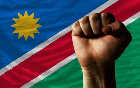 Hard fist in front of namibia flag symbolizing power Stock Photos