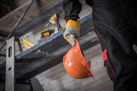 Hard Hat Construction Zone. Contractor with Orange Safety Hard Hat in Hand. 库存照片