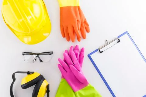 Hard Hat, Goggles, Earmuffs, Two Pairs of Rubber Gloves and Clipboard Stock Photos