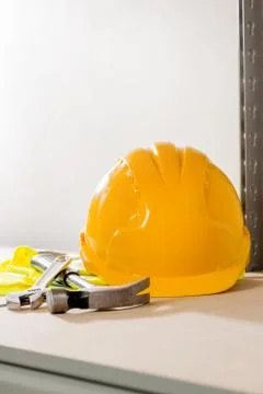 Hard Hat, Hammer, Spanner, and Gloves on Steel-Framed Shelf Stock Photos