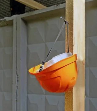Hard hat hangs on a nail Stock Photos