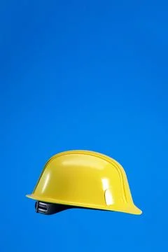 Hard hat isolated on blue vertical background with copy space, 3d render. Stock Illustration