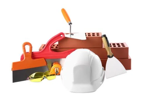 Hard hat, red bricks, trowel, measuring tape, goggles and putty knives isol.. Stock Photos
