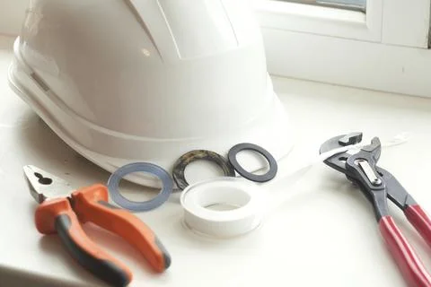 Hard Hat with Tools and Washers on Windowsill Stock Photos
