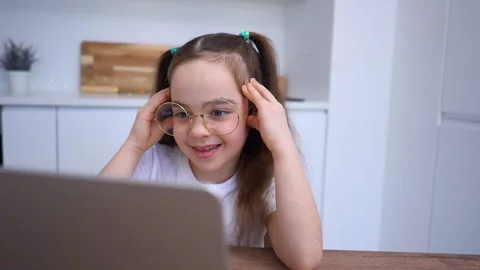 Hard learning. Smiling elementary school student with glasses talking to teacher Stock Footage 239318844