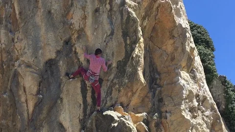 Hard long move on the climbing route Stockbeeldmateriaal 85823529