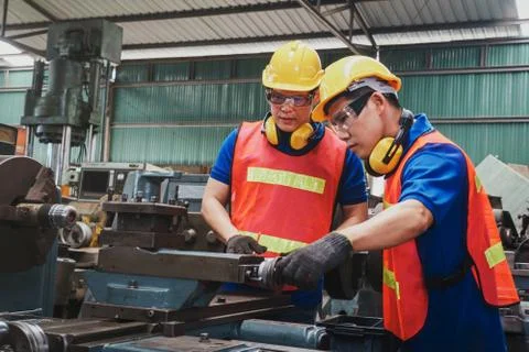 Hard mechanical team with checking on production in a factory. Stock Photos