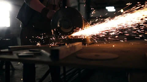 Hard men work. Sparks fly from metal cutting Stock Footage 99825305