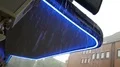 Hard rain pouring from canopy with blue neon light in Brunswick city 4k or 4k+ Resolution