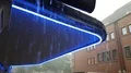 Hard rain pouring from canopy with blue neon light in Brunswick city 4k or 4k+ Resolution
