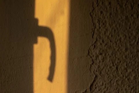 Hard shadow of window handle on the wall, high contrast light Photos