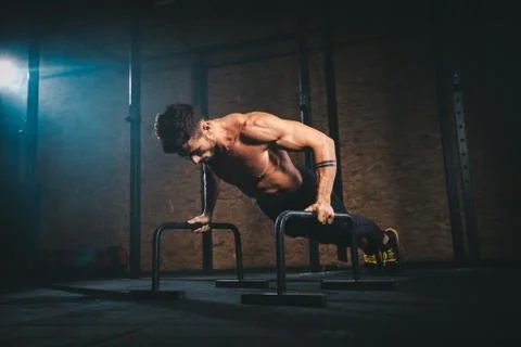 Hard training workout for a body guy in a cross fitness class complex of Stock Photos