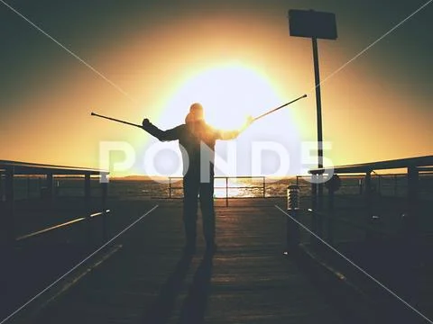 Hard walk of hurt man with crutches on port pier. Stock Photos