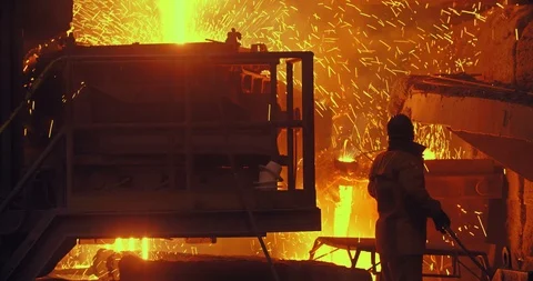Hard work in a foundry. Metal smelting furnace in steel mill. Molten metal Stock Footage 125110314