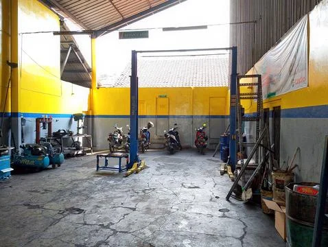 Hard at Work: Inside a Busy Motorcycle Repair Shop Stock Photos