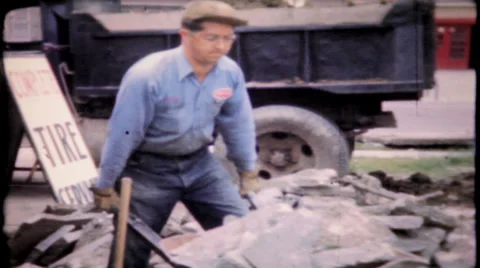 Hard work, man loads concrete in wheelbarrow 1950s vintage film home movie 623 Stock Footage 32596941