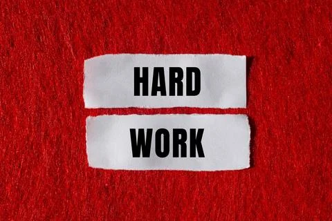 Hard Work message written on ripped torn paper background. Conceptual Hard .. Foto stock
