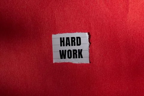 Hard Work message written on ripped torn paper background. Conceptual Hard .. Foto stock