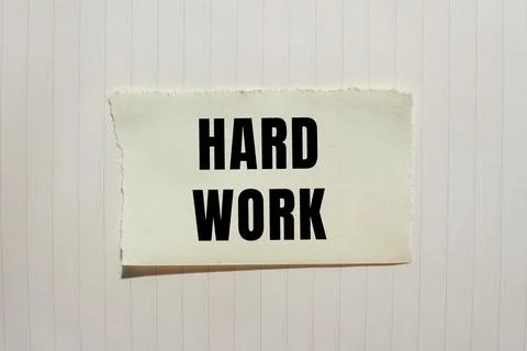 Hard Work message written on ripped torn paper background. Conceptual Hard .. Foto stock