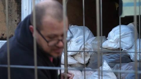 Hard work of transporter loading heavy sacks Stockbeeldmateriaal 328643836