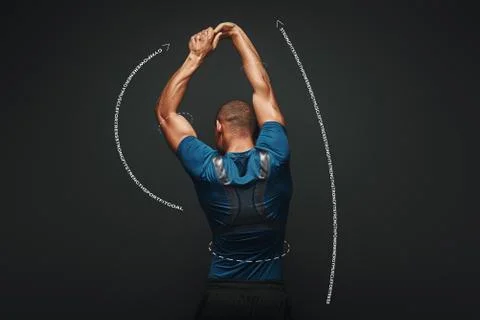 Hard work will solve your problems. Sportsman is stretching standing over dark Stock Photos