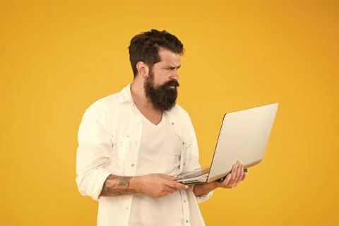 Hard working. Programmer with computer. brutal man surfing internet. hipster use 写真素材