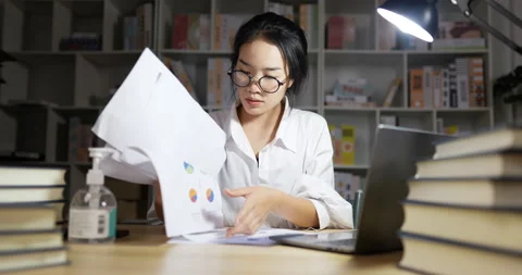 Hard working women finding document and throws documents at night.  Stock Footage 200928472