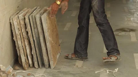 Hard working Worker, removing tiles, keeping tiles aside for recycle use. Stock Footage 245096442