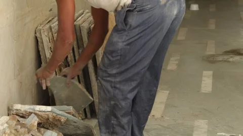 Hard working Worker, removing tiles, keeping tiles aside for recycle use. Stock Footage 245096453