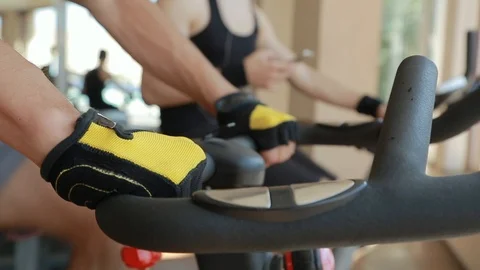 Hard Working Young Athlete Trains on Spinning Exercise Bike Stock Footage 91921077