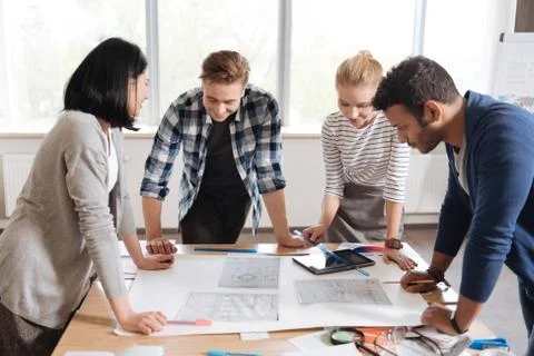 Hard working young engineers looking at the drawings Stock Photos