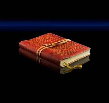 Hardback book on shiny black surface with reflection. Stock Photos