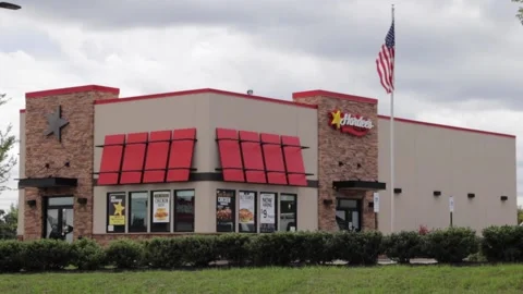 Hardees fast food restaurant front view on a cloudy day Stock Footage 157739226