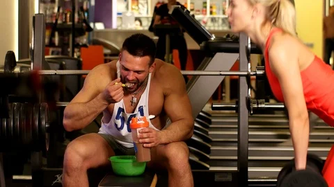 A hardened person eats after a workout Stock Footage 75376696