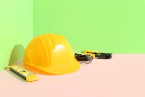 Hardhat and construction tools on color background Stock Photos