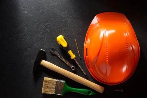 Hardhat and tools  on black Stock Photos