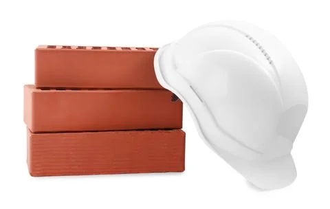 Hardhat with bricks isolated on white. Construction materials and safety eq.. Stock Photos