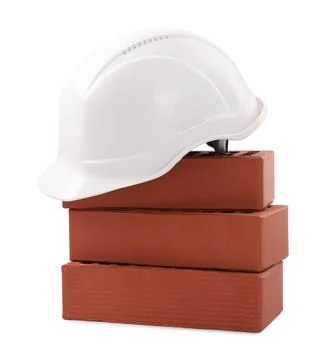 Hardhat with bricks isolated on white. Construction materials and safety eq.. Stock Photos