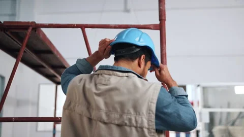 Hardhat, man and back of construction worker on site by scaffolding for property Stock Footage 341548814