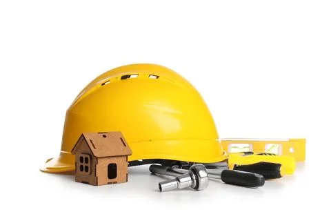 Hardhat with set of construction tools and house model isolated on white back Stock Photos
