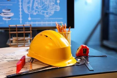Hardhat with tools on engineer's desk in office Stock Photos