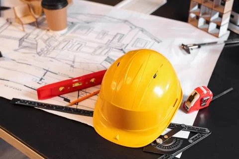 Hardhat with tools on engineer's desk in office, closeup Stock Photos