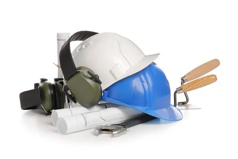 Hardhats with set of construction tools and house plans isolated on white bac Stock Photos