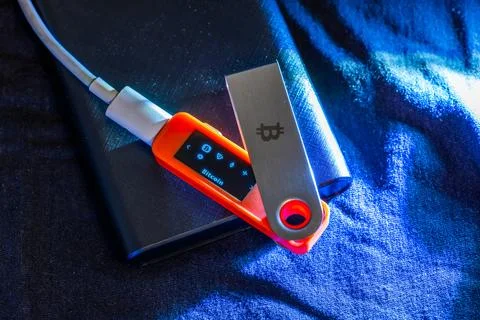 Hardware Bitcoin wallet in dark setting Stock Photos