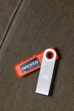 Hardware Bitcoin wallet with hacked message on screen Stock Photos