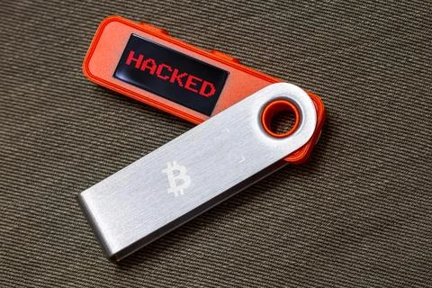 Hardware Bitcoin wallet with hacked message on screen Stock Photos