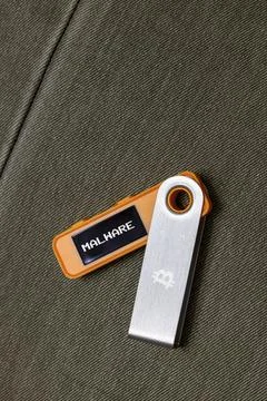 Hardware Bitcoin wallet in with Malware message on screen Stock Photos