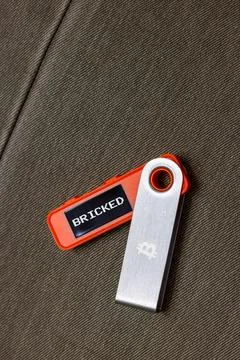 Hardware Bitcoin wallet with message bricked on screen Stock Photos